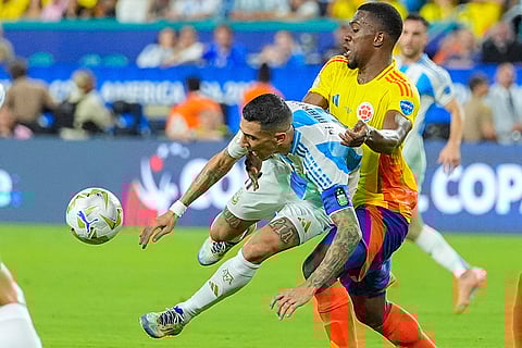 Angel Di Maria and Carlos Cuesta vie for the ball